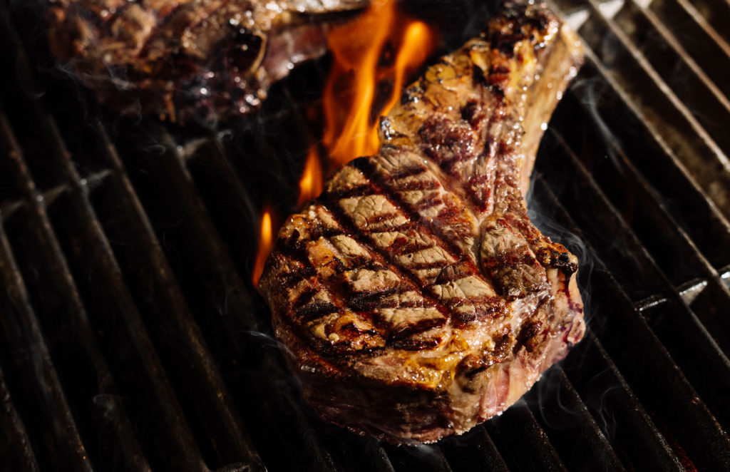 Dry-aged beef on the grill at Tapestry Bar & Grill.